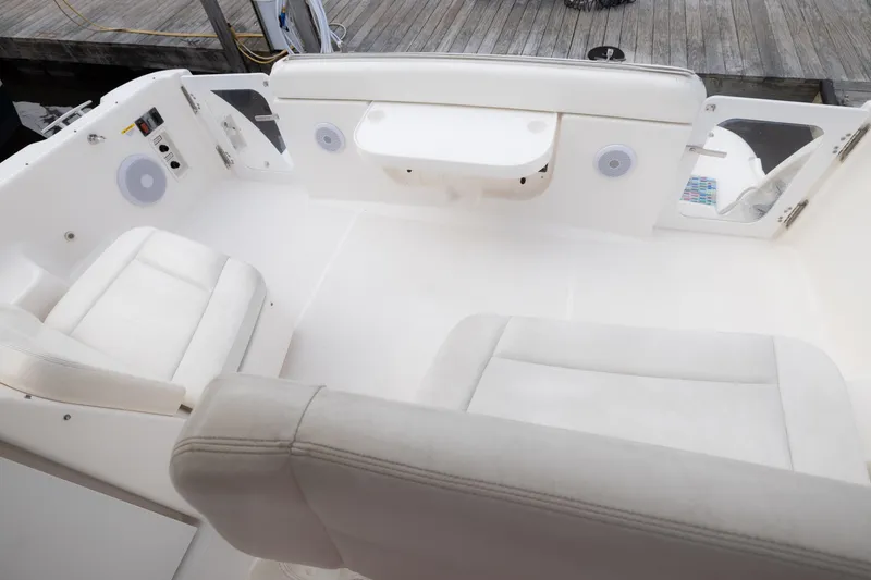 Slide: The Image of 2004 Tiara Yachts 3600 Sovran cockpit with white seating and modern amenities. - 12