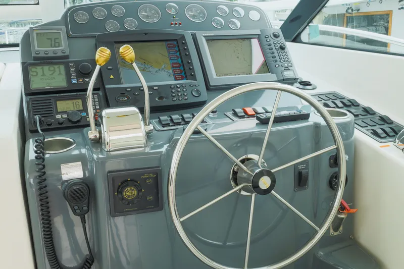 Slide: The Image of Helm of 2004 Tiara Yachts 3600 Sovran with navigation instruments and steering wheel. - 13