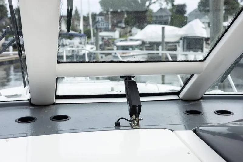 Slide: The Image of Interior view of 2004 Tiara Yachts 3600 Sovran cockpit with windshield and cup holders. - 15