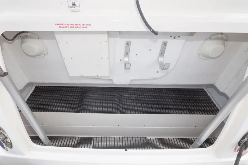 Slide: The Image of Storage compartment of a 2004 Tiara Yachts 3600 Sovran, featuring hooks and non-slip flooring. - 21