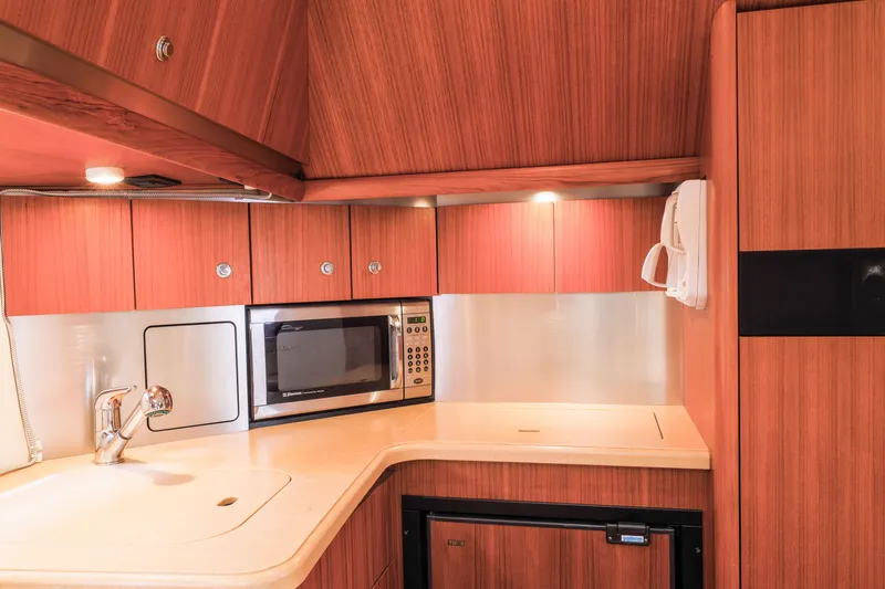 Slide: The Image of Luxurious 2004 Tiara Yachts 3600 Sovran kitchen with wood cabinetry and modern appliances. - 4