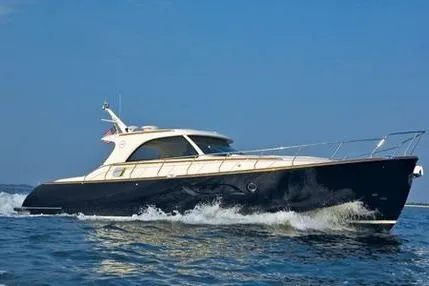 The Image of 2009 Mochi Craft 44 Dolphin yacht cruising on open water under clear blue skies. - 0