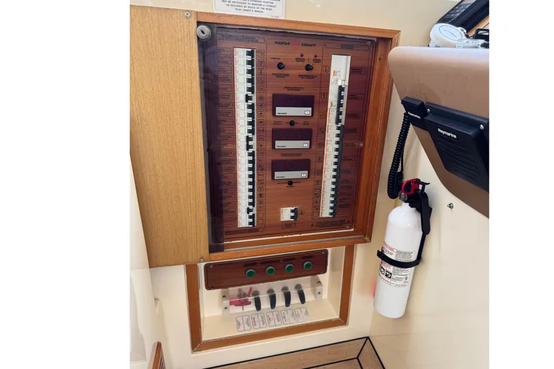 Slide: The Image of Electrical panel of 2009 Mochi Craft 44 Dolphin yacht with fire extinguisher and communication device. - 10