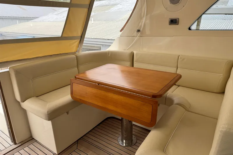 Slide: The Image of Luxurious seating area on 2009 Mochi Craft 44 Dolphin yacht with wooden table. - 11