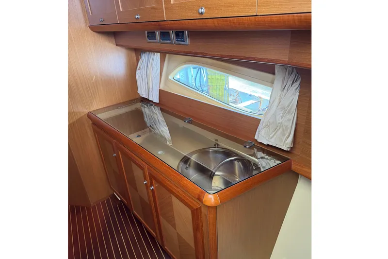 Slide: The Image of Interior of 2009 Mochi Craft 44 Dolphin yacht with wooden cabinetry and sink. - 13