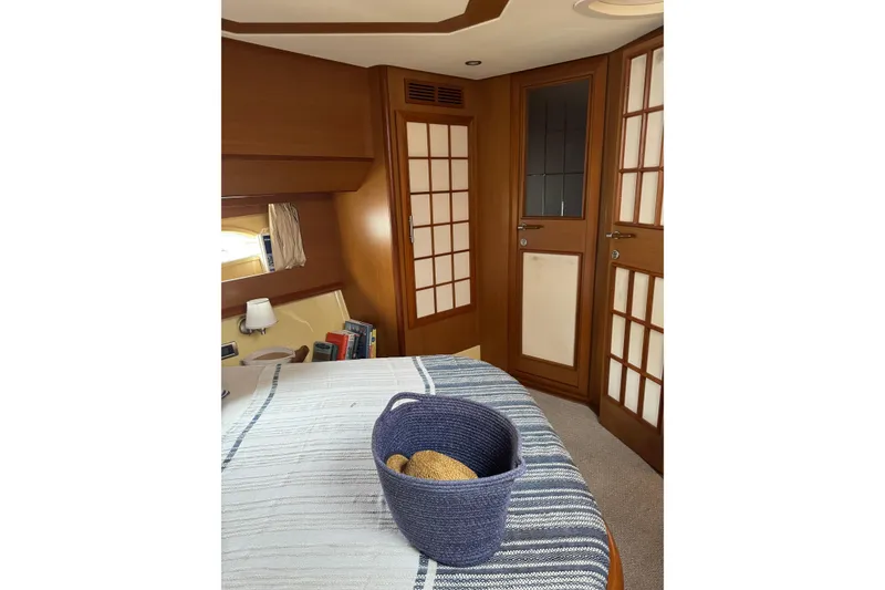 Slide: The Image of Luxurious cabin interior of 2009 Mochi Craft 44 Dolphin yacht with elegant wood finishes. - 16
