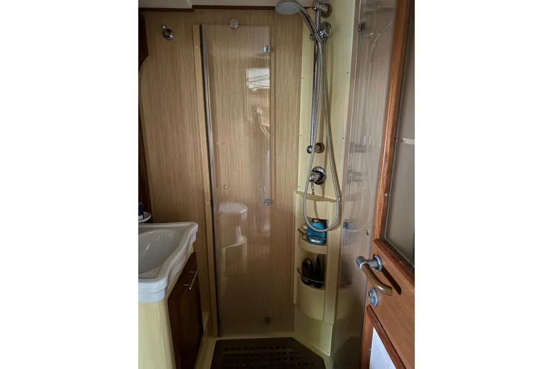 Slide: The Image of Bathroom interior of 2009 Mochi Craft 44 Dolphin yacht, featuring shower and sink. - 17