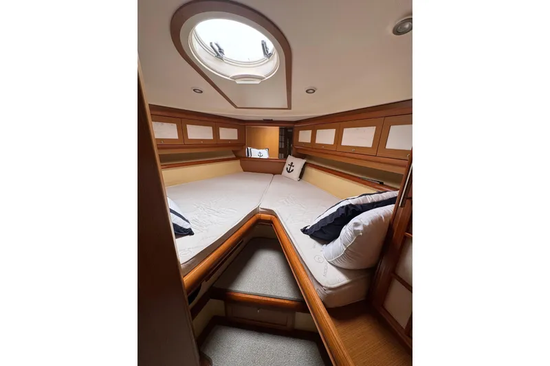 Slide: The Image of Luxurious cabin interior of 2009 Mochi Craft 44 Dolphin yacht, featuring elegant wood finishes. - 18