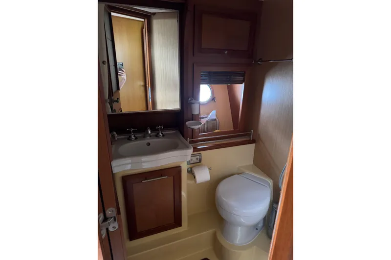 Slide: The Image of Bathroom interior of 2009 Mochi Craft 44 Dolphin yacht, featuring sink and toilet. - 19
