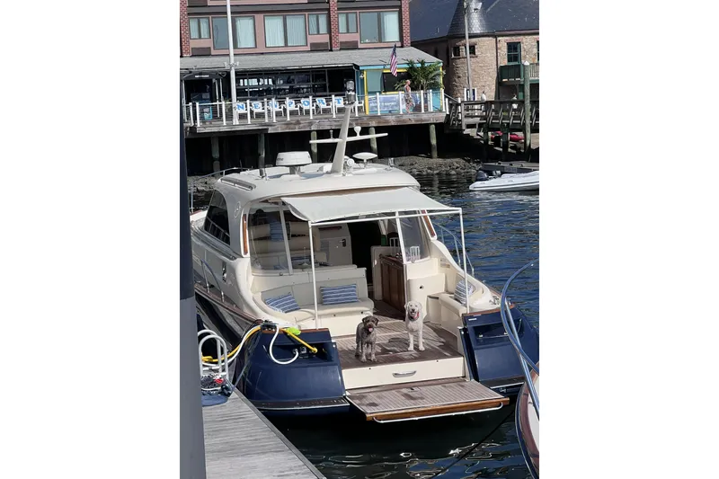Slide: The Image of 2009 Mochi Craft 44 Dolphin yacht docked with two dogs on deck. - 4