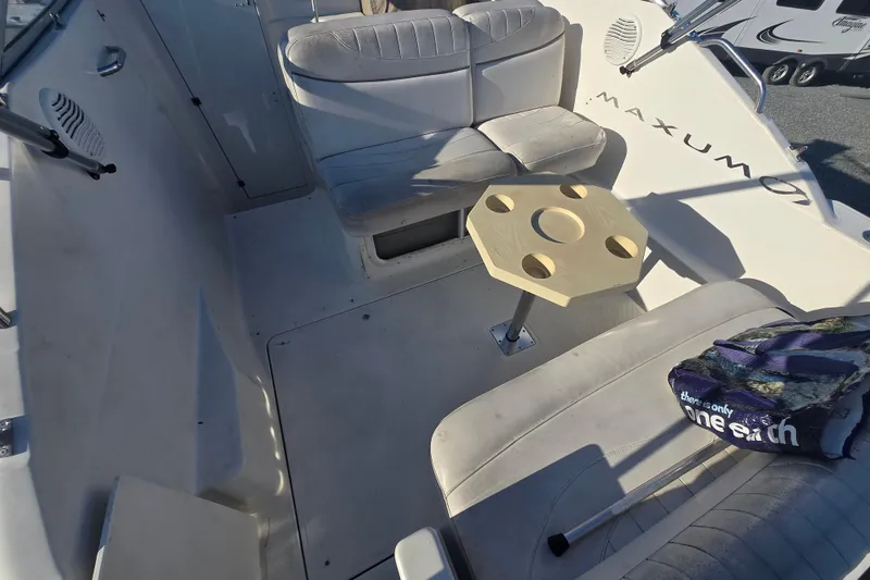 Slide: The Image of 2001 Maxum 2400 SCR boat interior with seating and table setup. - 14
