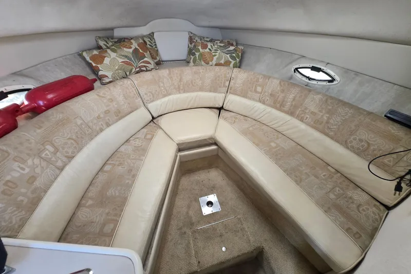 Slide: The Image of Interior of a 2001 Maxum 2400 SCR boat with beige seating and floral cushions. - 19
