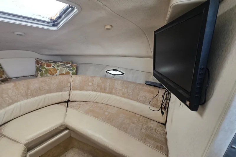 Slide: The Image of Interior of 2001 Maxum 2400 SCR boat with cozy seating and mounted TV. - 20