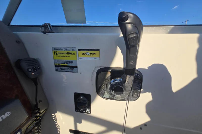 Slide: The Image of 2001 Maxum 2400 SCR boat control panel with capacity label and throttle lever. - 27
