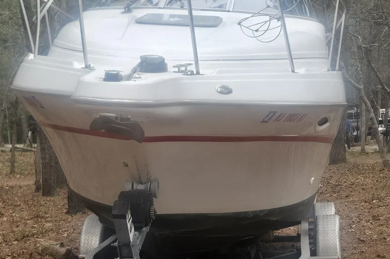 Slide: The Image of Compact bathroom in 2001 Maxum 2400 SCR boat with toilet, sink, and porthole. - 3