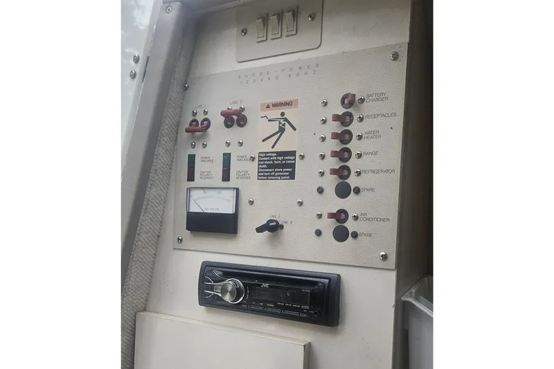 Slide: The Image of Electrical control panel of a 2001 Maxum 2400 SCR boat with switches and warning labels. - 30