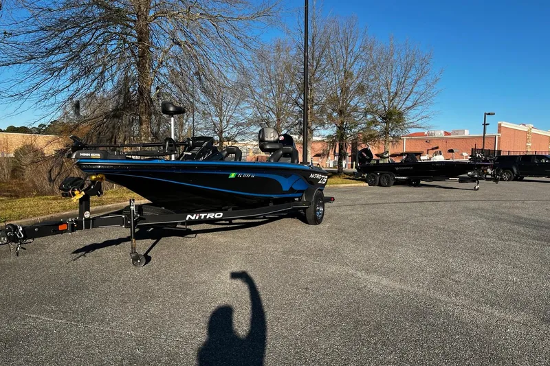 Slide: The Image of 2024 Nitro Z19 boat parked outdoors on a sunny day. - 2