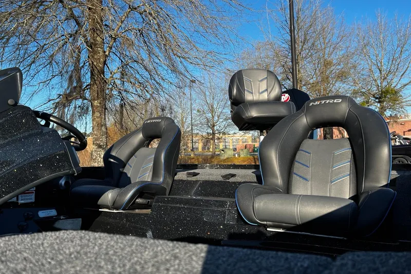 Slide: The Image of 2024 Nitro Z19 boat interior with sleek black seats and steering wheel. - 6