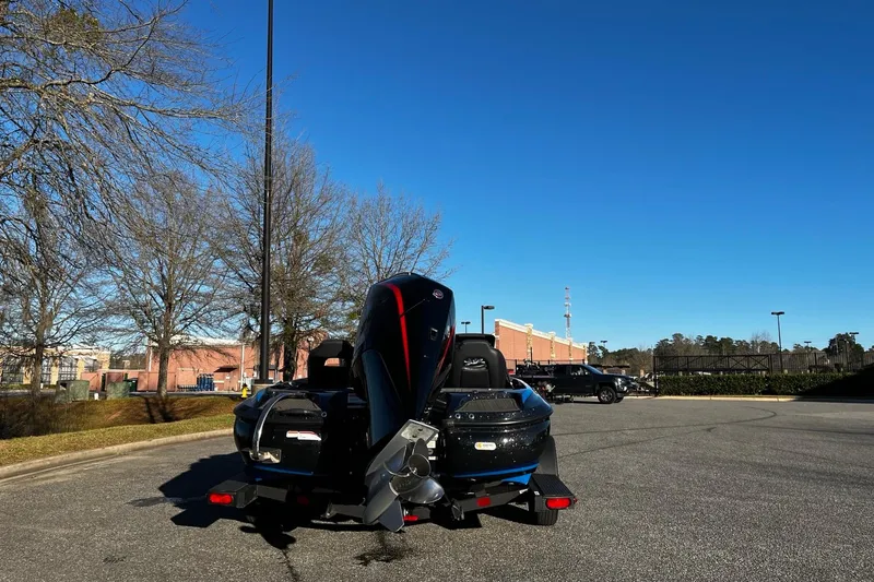 Slide: The Image of 2024 Nitro Z19 boat parked outdoors on a sunny day, showcasing its sleek design. - 9