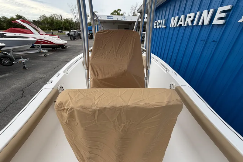 Slide: The Image of 2017 Tidewater 198 CC Adventure boat with covered seats at a marine dealership. - 17