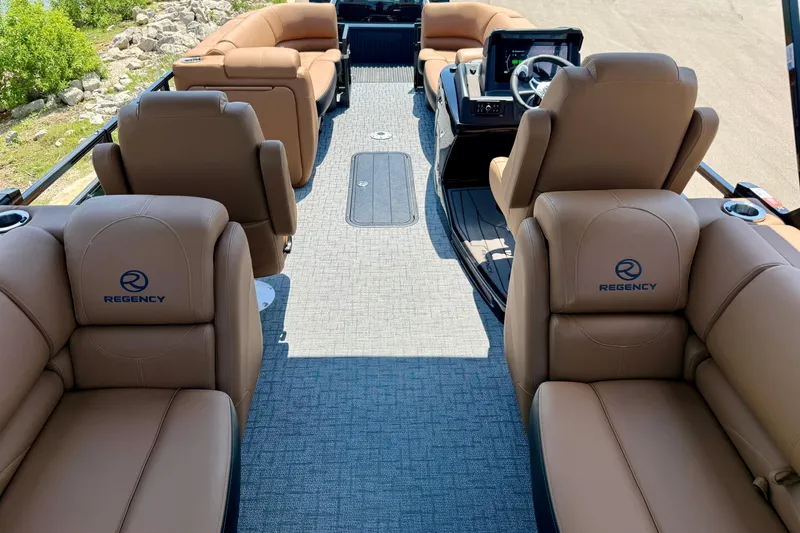Slide: The Image of Luxurious interior of 2026 Regency 230 DL boat with plush seating and modern dashboard. - 11