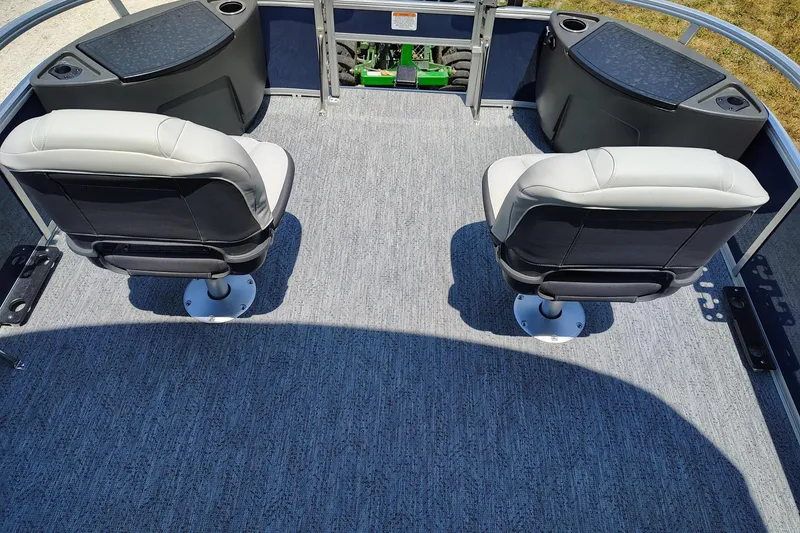 Slide: The Image of 2026 Sun Tracker Bass Buggy 18 DLX interior with two swivel seats and carpeted flooring. - 2