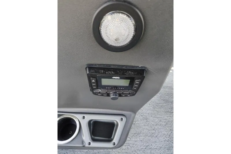 Slide: The Image of 2026 Sun Tracker Bass Buggy 18 DLX interior with stereo system and cup holder. - 3
