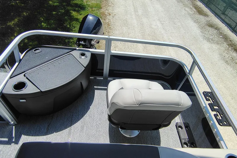 Slide: The Image of 2026 Sun Tracker Bass Buggy 18 DLX pontoon boat interior with seating and motor view. - 7