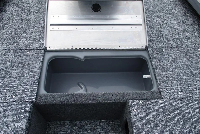 Slide: The Image of Open storage compartment in 2026 Tracker Pro 170 boat, featuring gray carpeted interior. - 13
