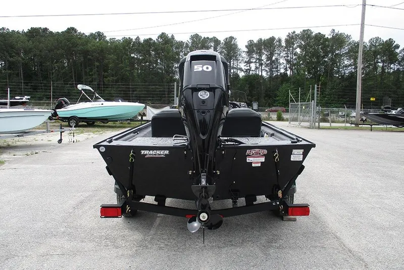 Slide: The Image of 2026 Tracker Pro 170 boat with 50 HP motor, parked outdoors. - 7