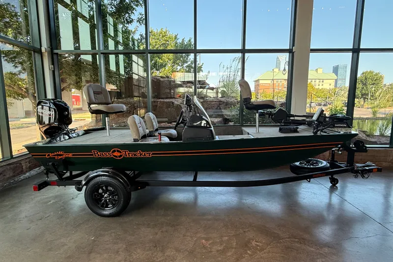 The Image of 2026 Tracker Bass Tracker Classic Limited boat displayed indoors with scenic window view. - 0