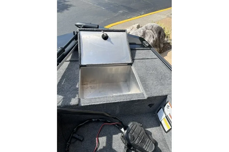 Slide: The Image of Open storage compartment on 2026 Tracker Panfish 17 boat, featuring carpeted interior. - 42