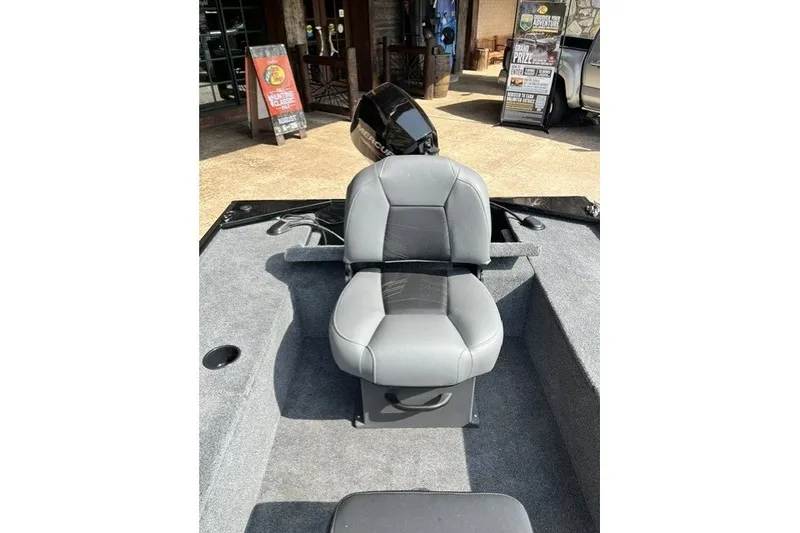 Slide: The Image of 2026 Tracker Panfish 17 boat seat with gray upholstery and outdoor setting. - 44