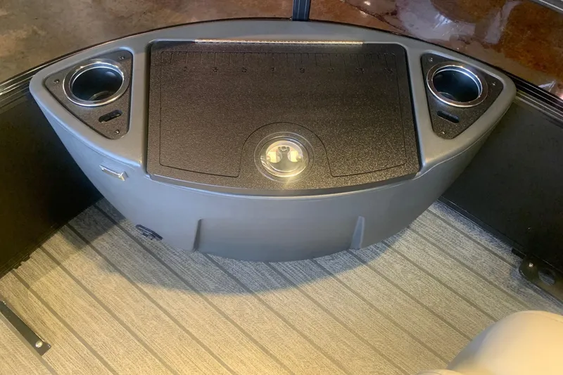 Slide: The Image of Interior of 2026 Ranger 223F boat with cup holders and storage compartment. - 11