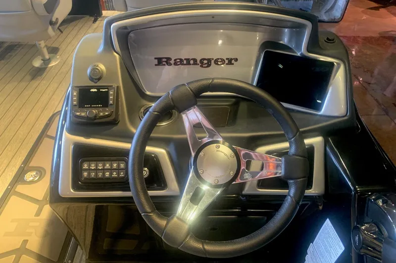 Slide: The Image of 2026 Ranger 223F boat dashboard with steering wheel and control panel. - 6