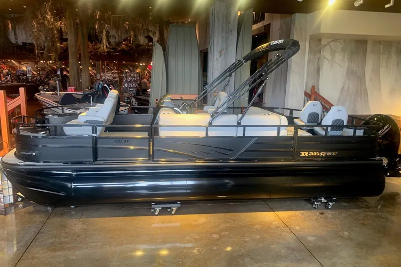 The Image of 2026 Ranger 223F pontoon boat displayed indoors with sleek black design. - 0