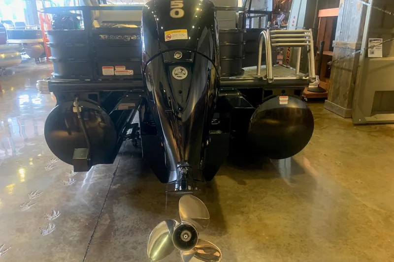 Slide: The Image of 2026 Ranger 223F boat with a 50 HP outboard motor in showroom. - 2