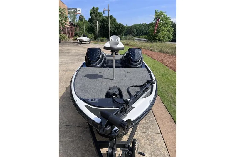 Slide: The Image of 2026 Nitro Z17 fishing boat with trolling motor, parked outdoors on a sunny day. - 99