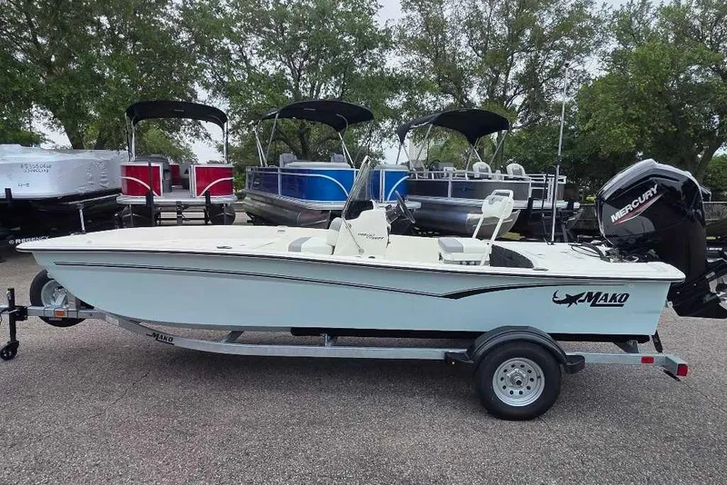 Slide: The Image of 2026 Mako Pro Skiff 17 CC boat on trailer, parked outdoors. - 2