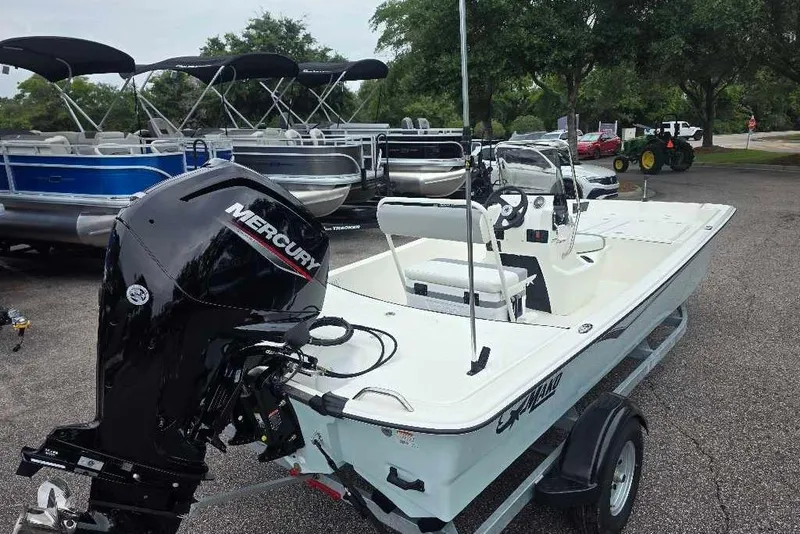 Slide: The Image of 2026 Mako Pro Skiff 17 CC boat with Mercury engine on trailer. - 3