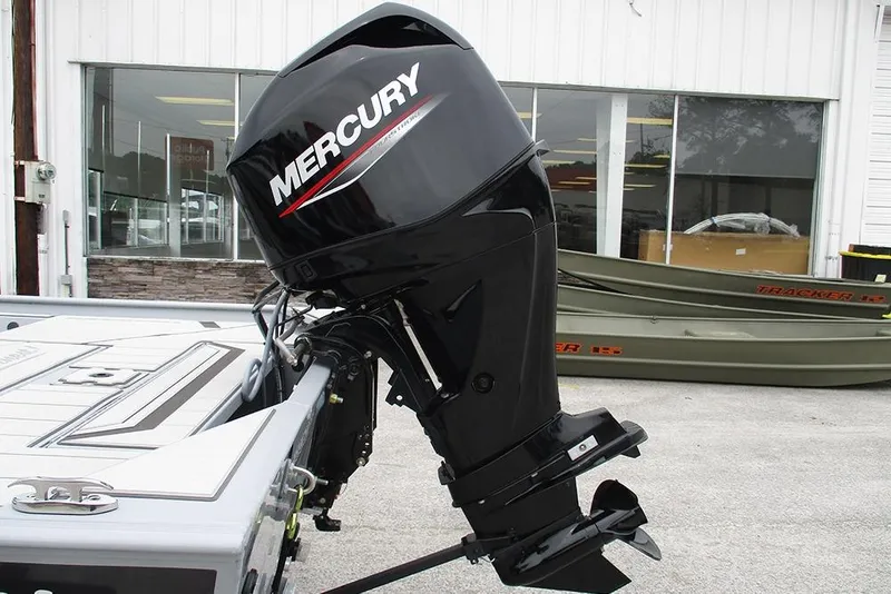 Slide: The Image of 2026 Tracker Bass Tracker Classic CC with Mercury outboard motor in a showroom. - 10