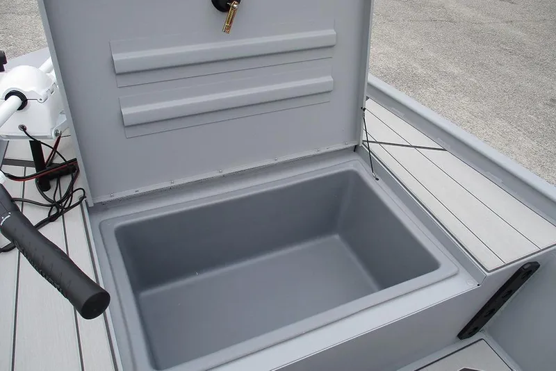 Slide: The Image of 2026 Tracker Bass Tracker Classic CC boat storage compartment, open lid, gray interior. - 13