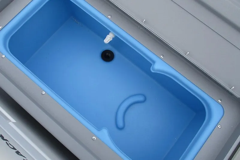 Slide: The Image of Livewell compartment in 2026 Tracker Bass Tracker Classic CC boat, featuring blue interior. - 23