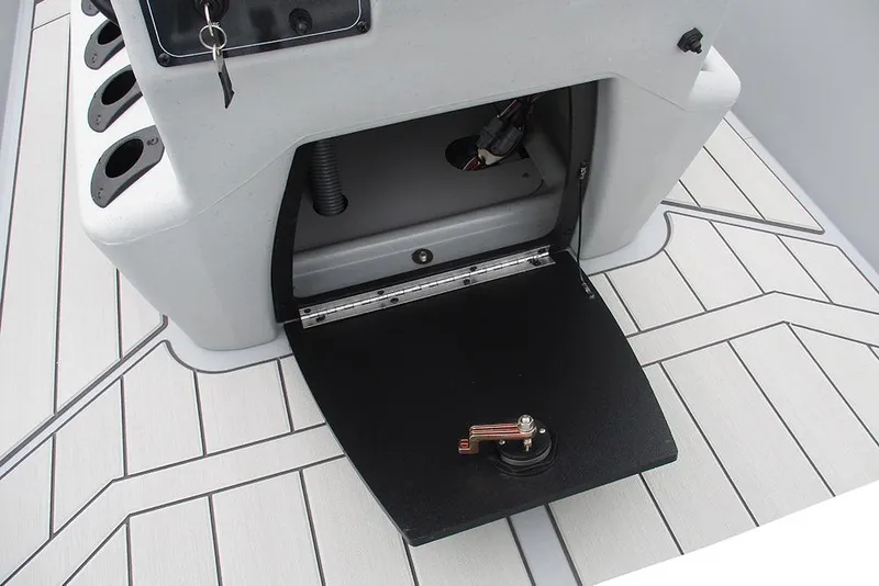 Slide: The Image of 2026 Tracker Bass Tracker Classic CC boat interior with open storage compartment and rod holders. - 25