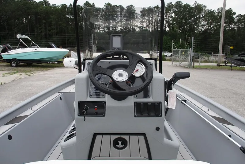 Slide: The Image of 2026 Tracker Bass Tracker Classic CC boat dashboard with steering wheel and controls. - 27