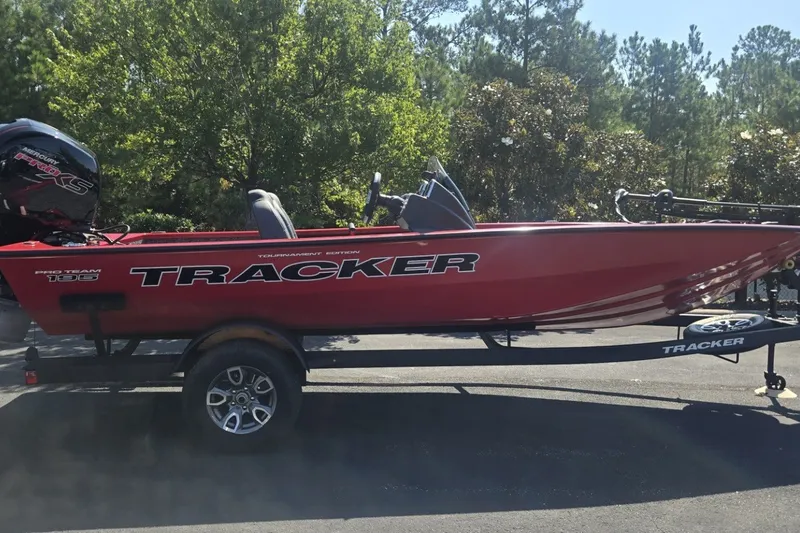 The Image of 2026 Tracker Pro Team 195 boat on trailer, red color, parked outdoors. - 0