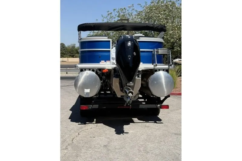 Slide: The Image of 2026 Sun Tracker Party Barge 24 XP3 pontoon boat, rear view with motor and trailer. - 4