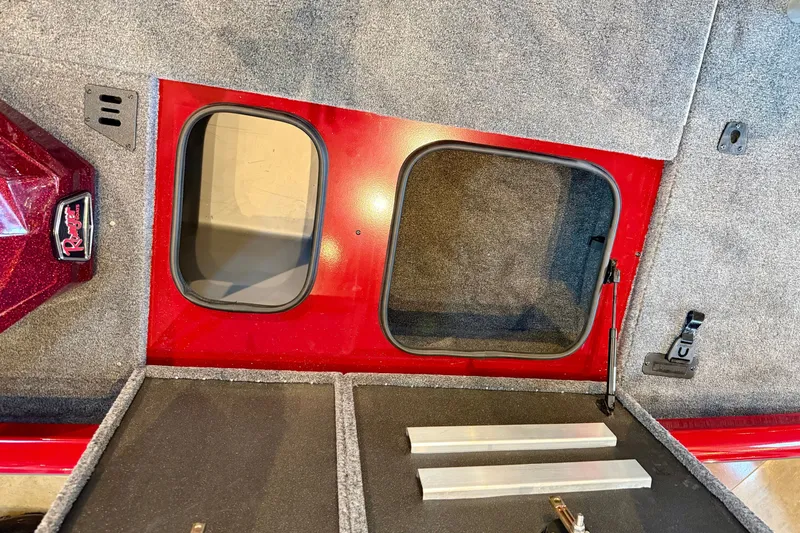 Slide: The Image of Interior view of 2026 Ranger RT188P boat storage compartments with red and gray finish. - 15