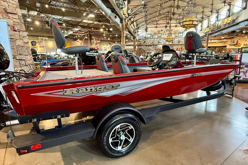 The Image of 2026 Ranger RT188P red fishing boat displayed indoors on a trailer. - 0