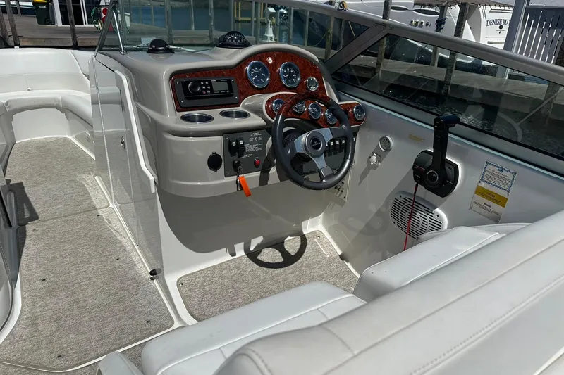 Slide: The Image of 2004 Formula 260 Bowrider boat interior with steering wheel and dashboard controls. - 10